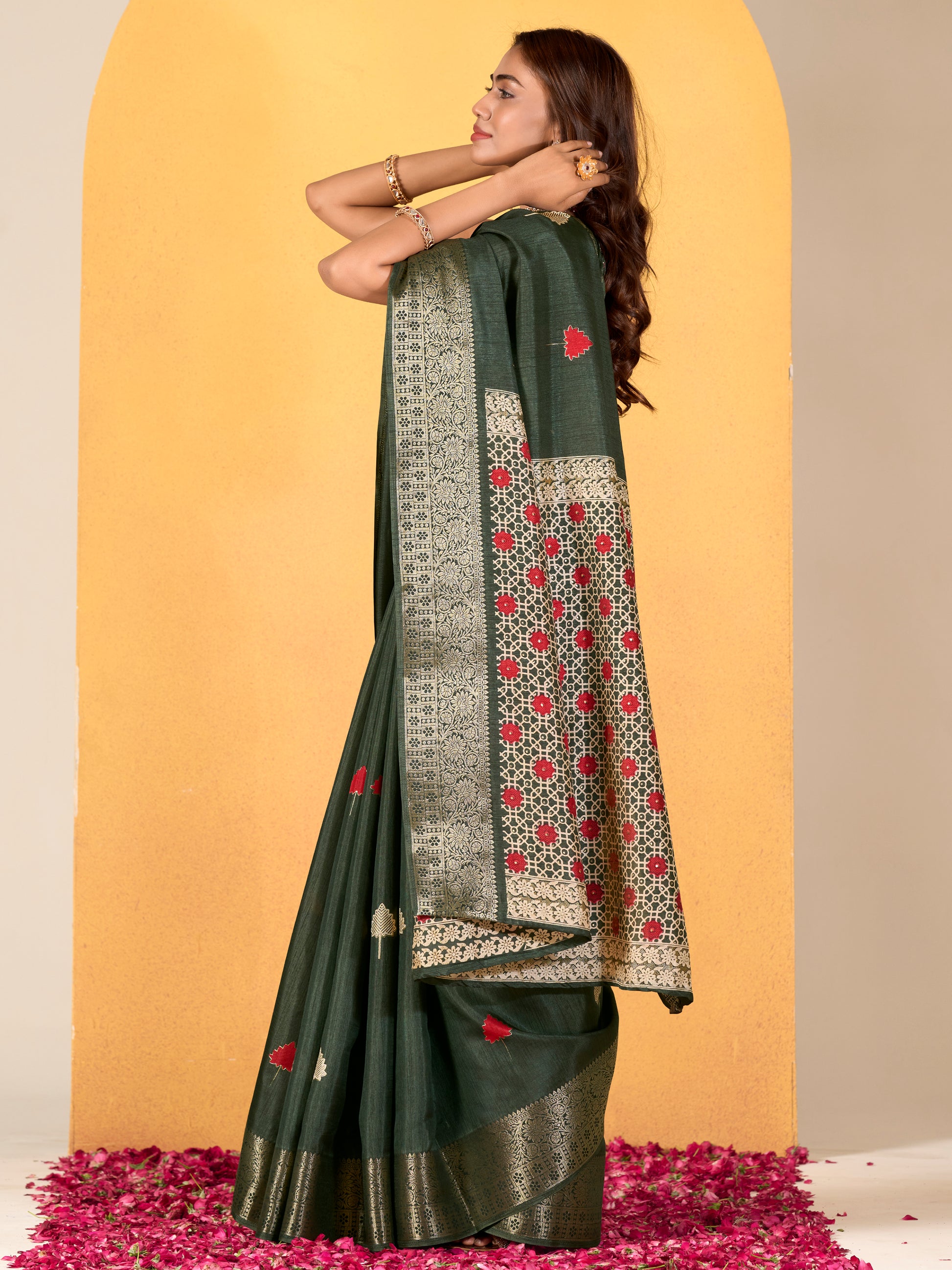Make your upcoming celebrations truly special with this stunning green dola silk saree. The saree features a harmonious blend of foil print and zari weaving, adding a touch of sophistication and texture to its vibrant green hue. With its intricate detailing and elegant design, this saree is perfect for festivals, events, and any occasion where you wish to make a memorable impression. Complementing the saree is a matching unstitched silk blouse, adorned with the same foil print and zari work. Measuring 5.50