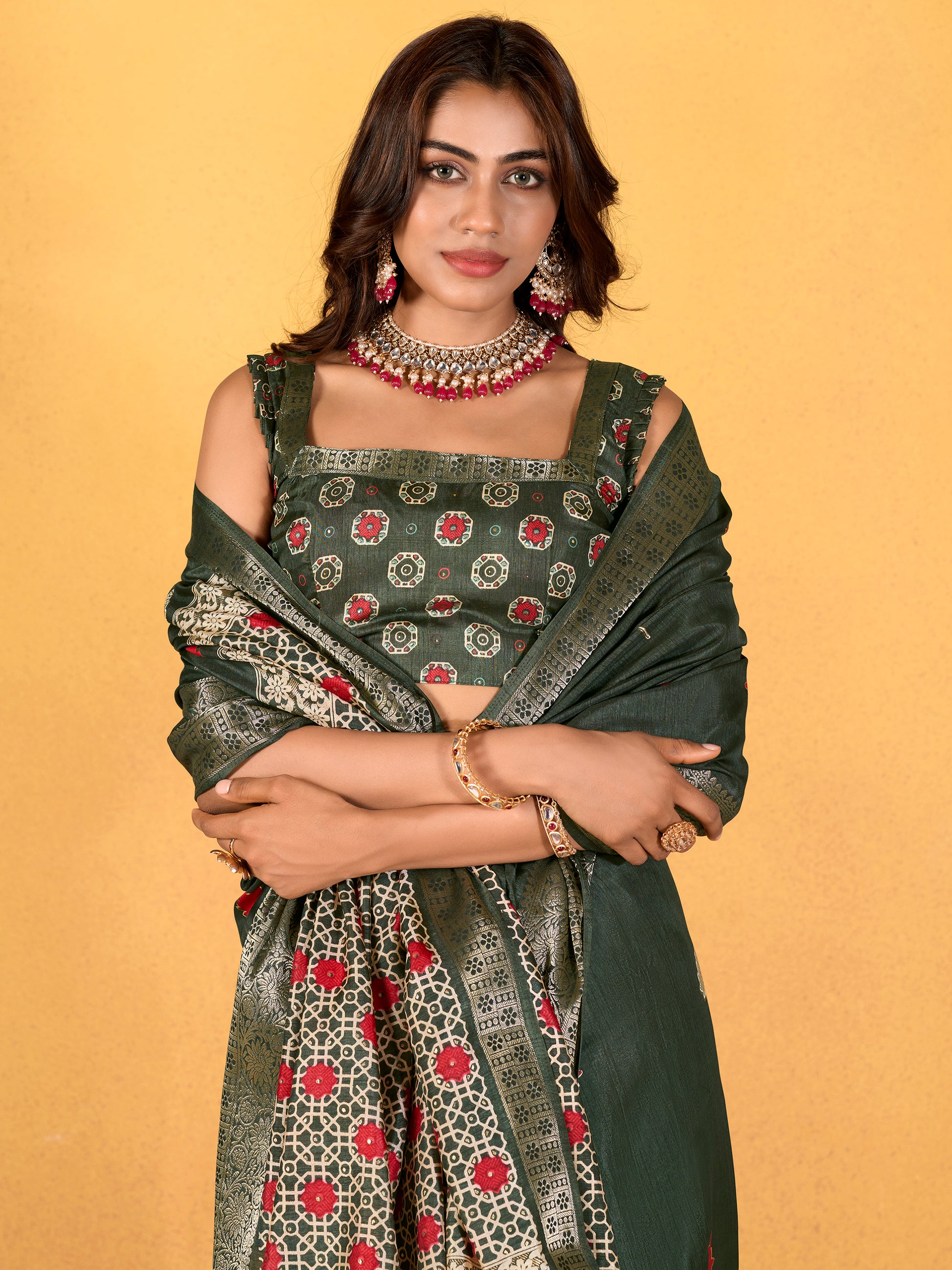 Make your upcoming celebrations truly special with this stunning green dola silk saree. The saree features a harmonious blend of foil print and zari weaving, adding a touch of sophistication and texture to its vibrant green hue. With its intricate detailing and elegant design, this saree is perfect for festivals, events, and any occasion where you wish to make a memorable impression. Complementing the saree is a matching unstitched silk blouse, adorned with the same foil print and zari work. Measuring 5.50