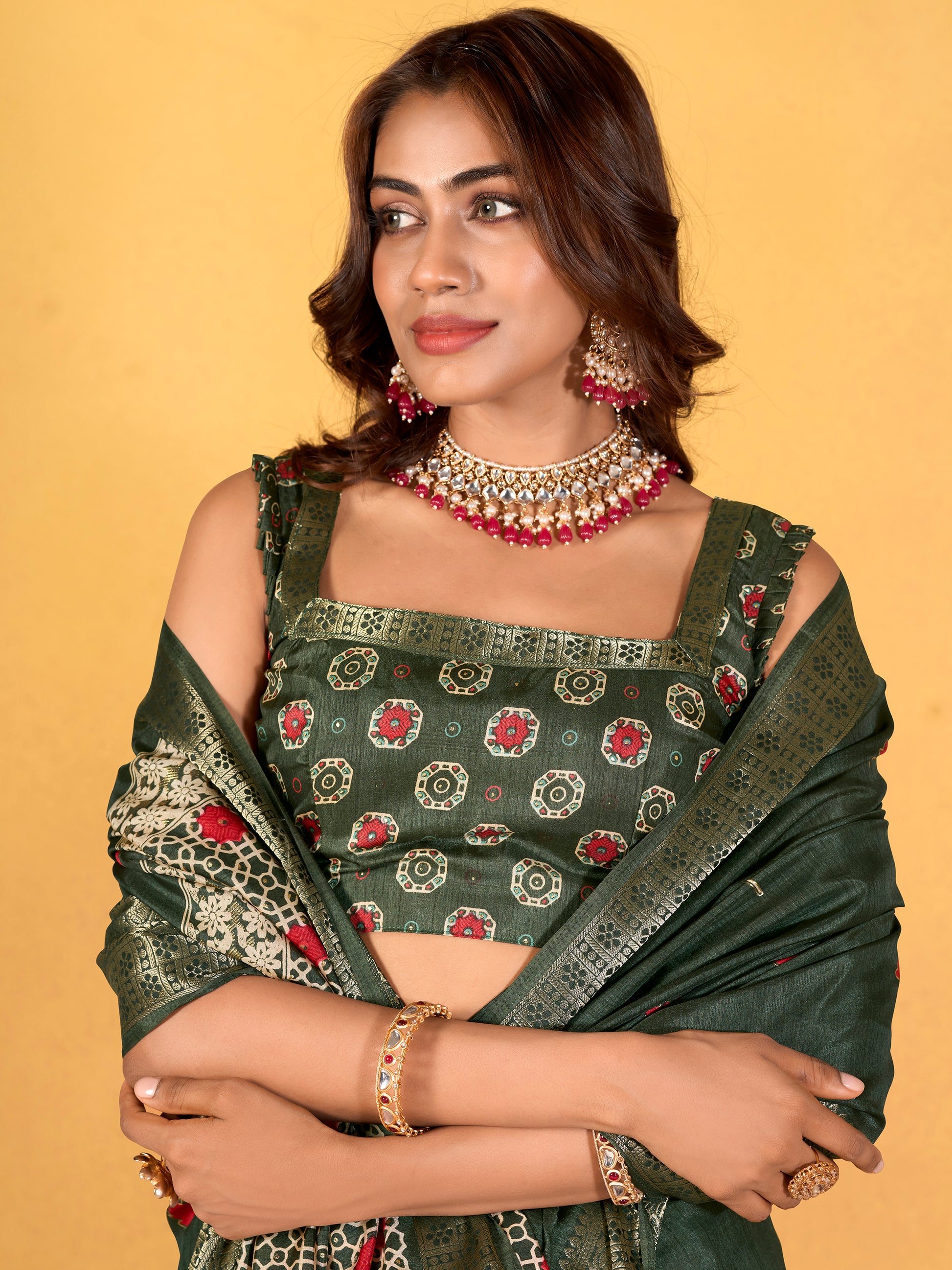 Make your upcoming celebrations truly special with this stunning green dola silk saree. The saree features a harmonious blend of foil print and zari weaving, adding a touch of sophistication and texture to its vibrant green hue. With its intricate detailing and elegant design, this saree is perfect for festivals, events, and any occasion where you wish to make a memorable impression. Complementing the saree is a matching unstitched silk blouse, adorned with the same foil print and zari work. Measuring 5.50