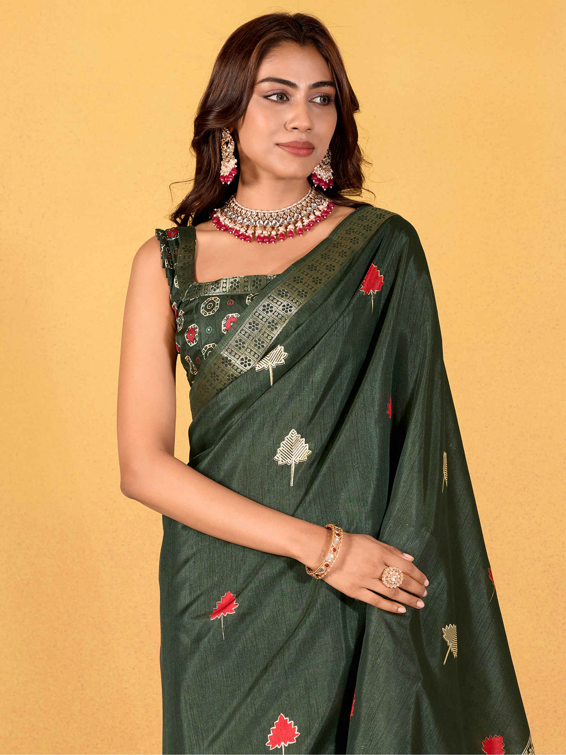 Make your upcoming celebrations truly special with this stunning green dola silk saree. The saree features a harmonious blend of foil print and zari weaving, adding a touch of sophistication and texture to its vibrant green hue. With its intricate detailing and elegant design, this saree is perfect for festivals, events, and any occasion where you wish to make a memorable impression. Complementing the saree is a matching unstitched silk blouse, adorned with the same foil print and zari work. Measuring 5.50