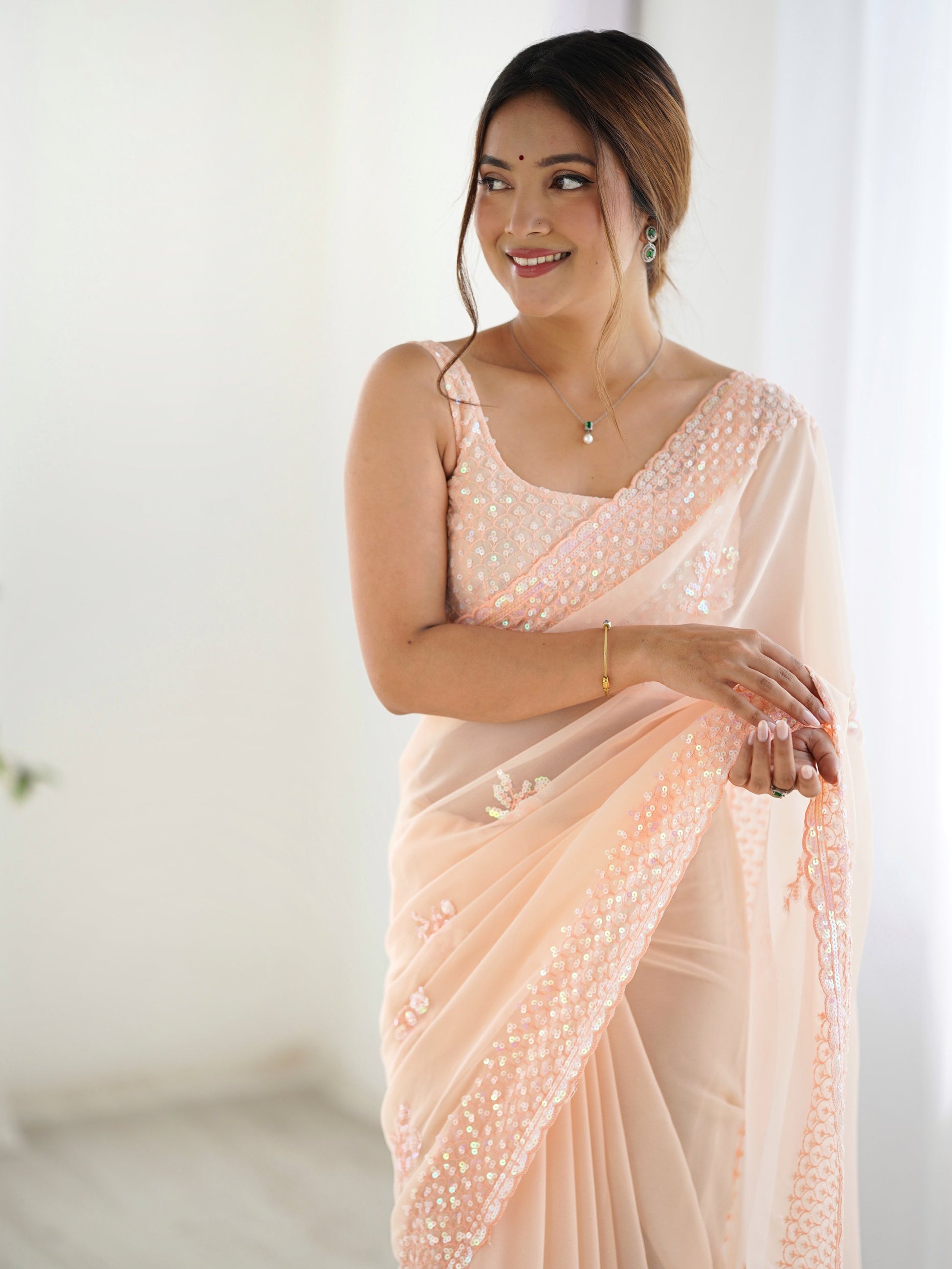Captivating Peach Sequins Embroidered Georgette Reception Wear Saree