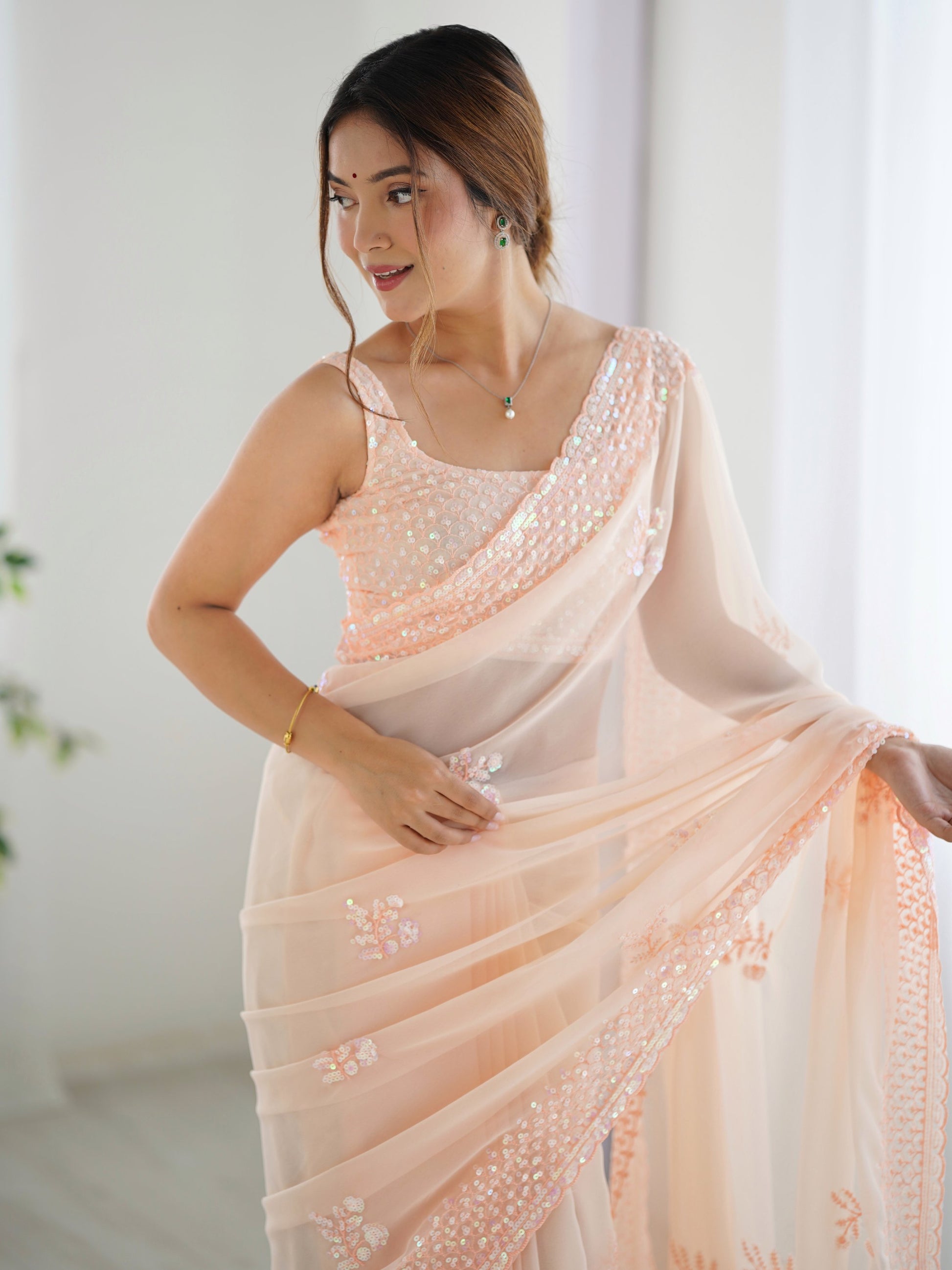 Captivating Peach Sequins Embroidered Georgette Reception Wear Saree