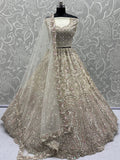 Charming Cream Zircon Work Net Bridesmaid Lehenga Choli With Dupatta