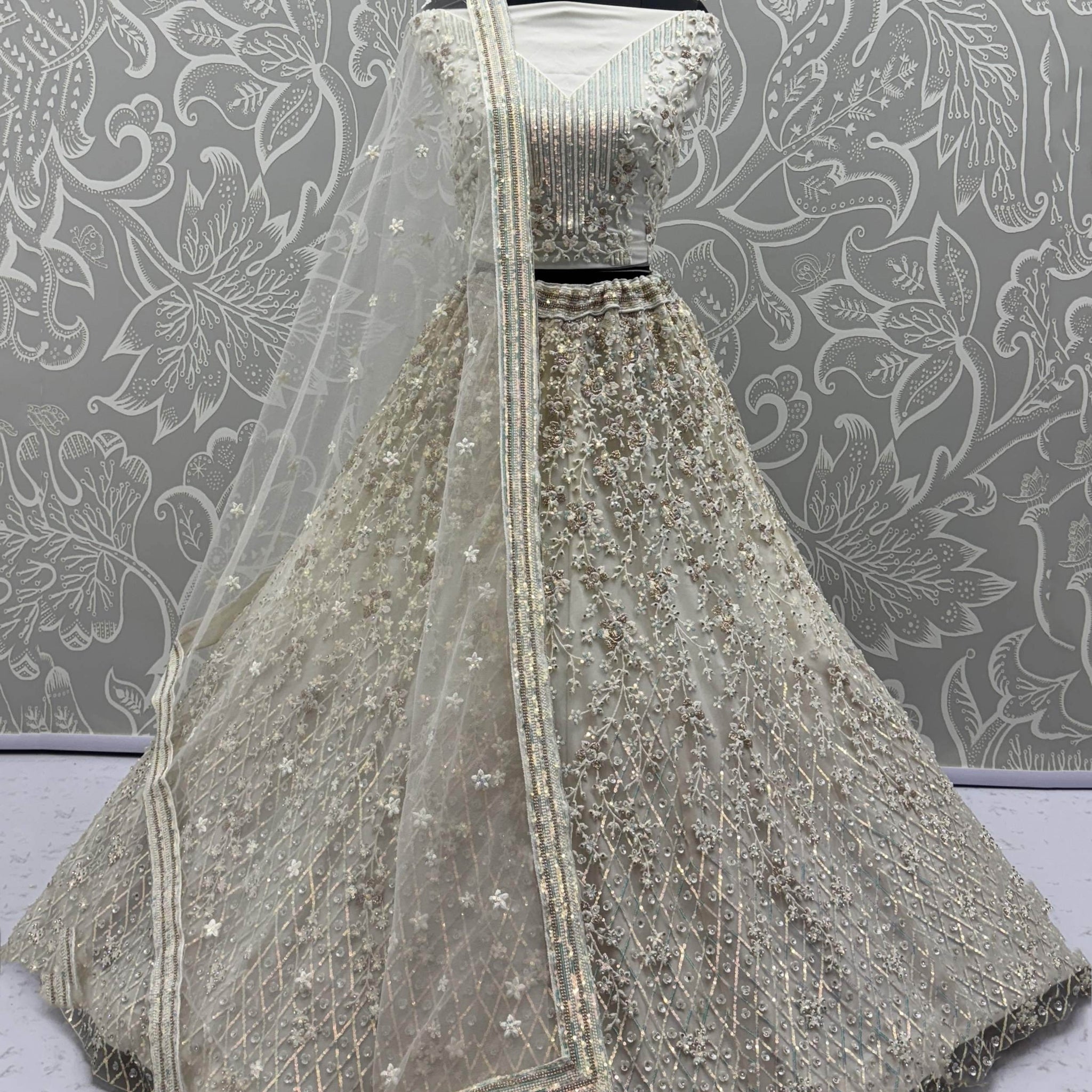 Dazzling Beige Zari Work Net Evening Wear Lehenga Choli With Dupatta