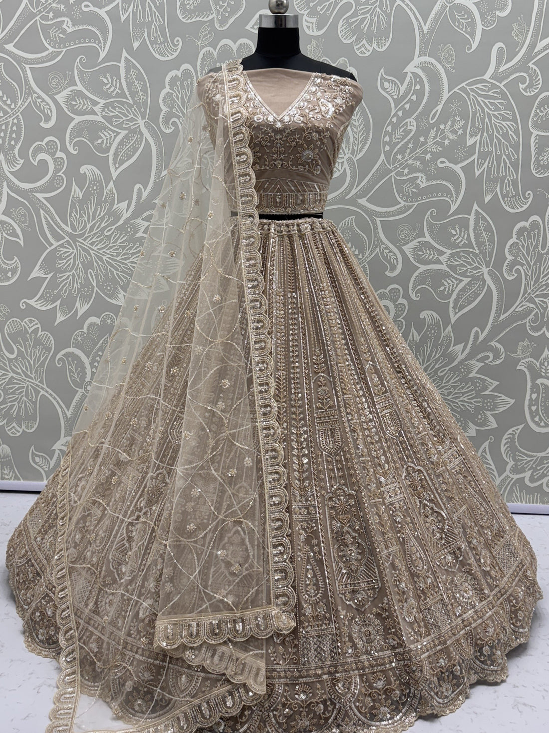 Enchanting Beige Embroidered Net Wedding Wear Lehenga Choli With Dupatta