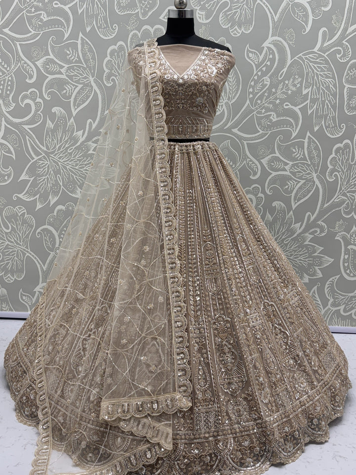 Enchanting Beige Embroidered Net Wedding Wear Lehenga Choli With Dupatta