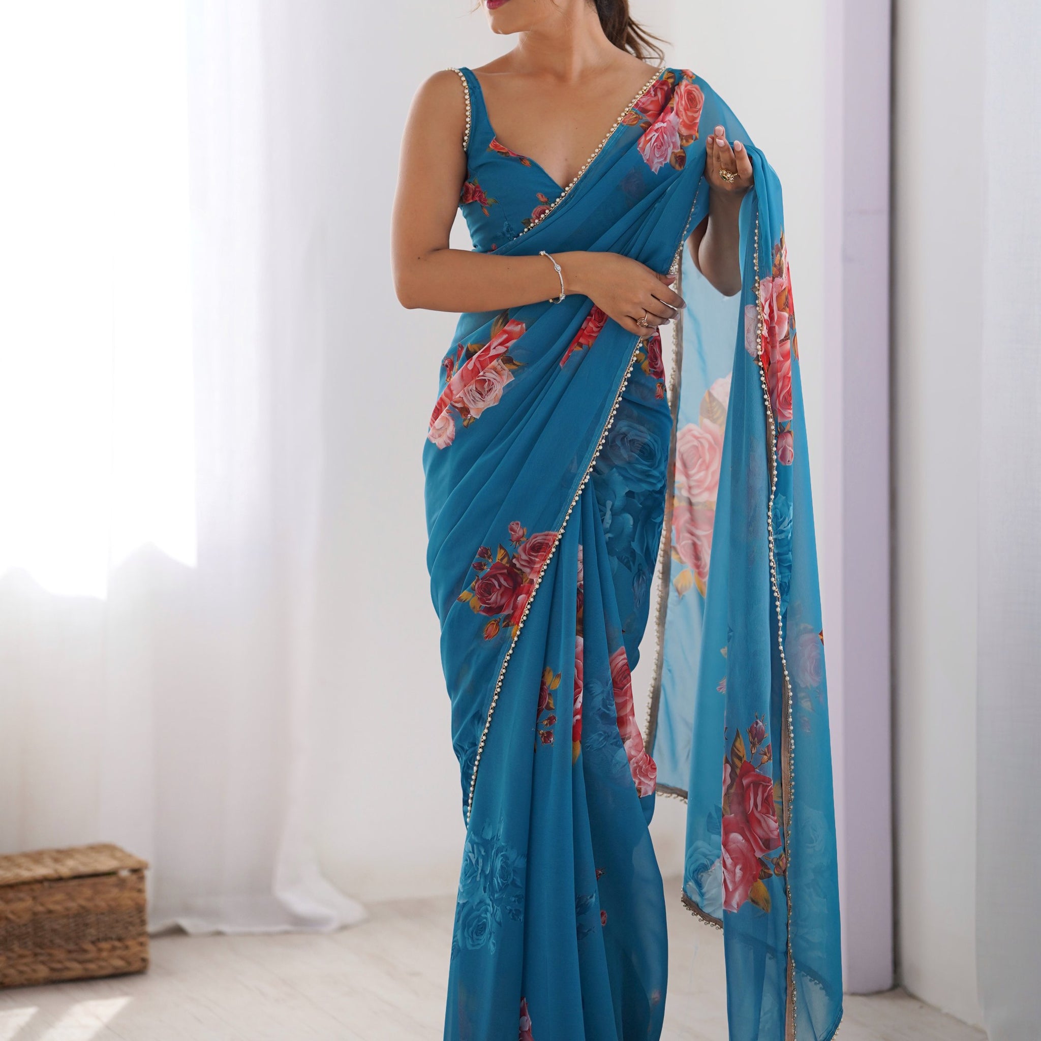 Attractive Teal Blue Floral Printed Georgette Casual Wear Saree