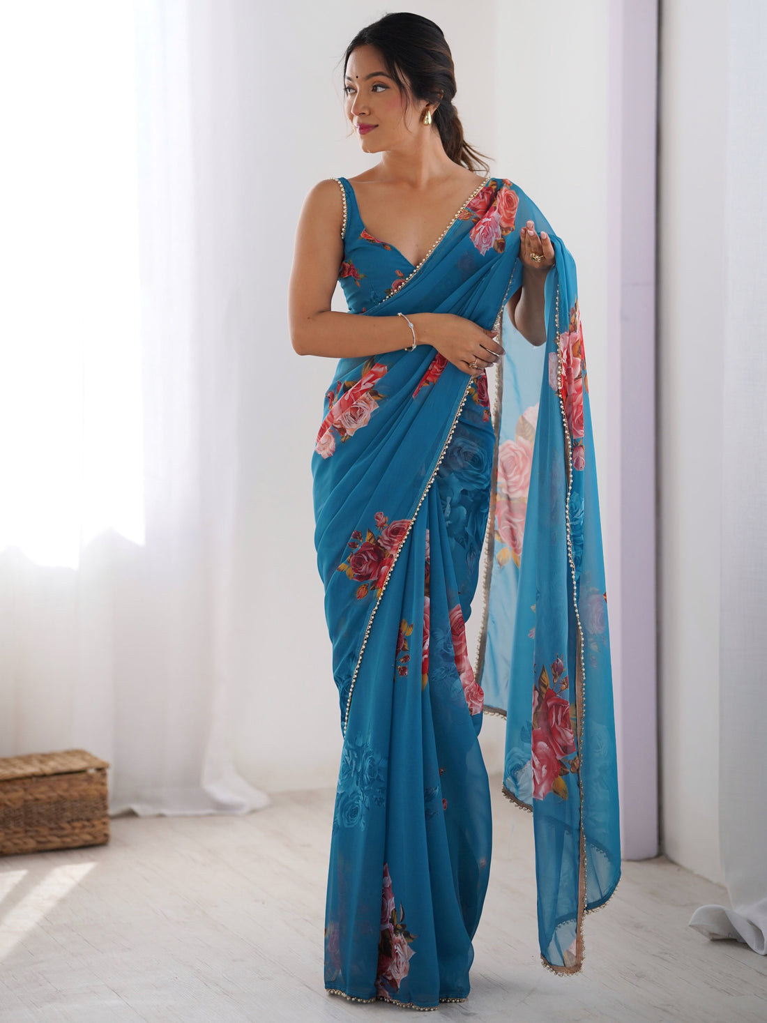 Attractive Teal Blue Floral Printed Georgette Casual Wear Saree
