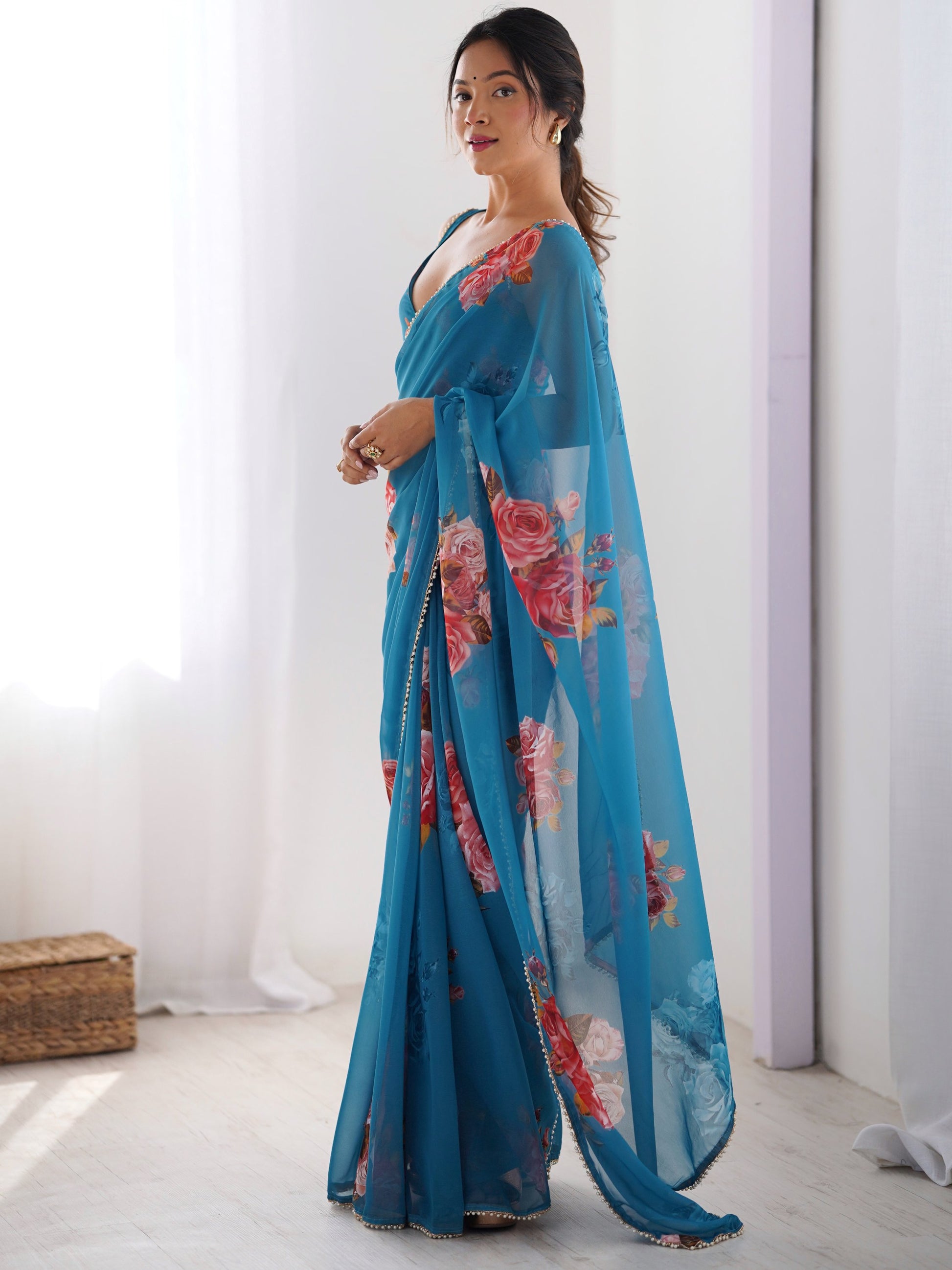 Attractive Teal Blue Floral Printed Georgette Casual Wear Saree