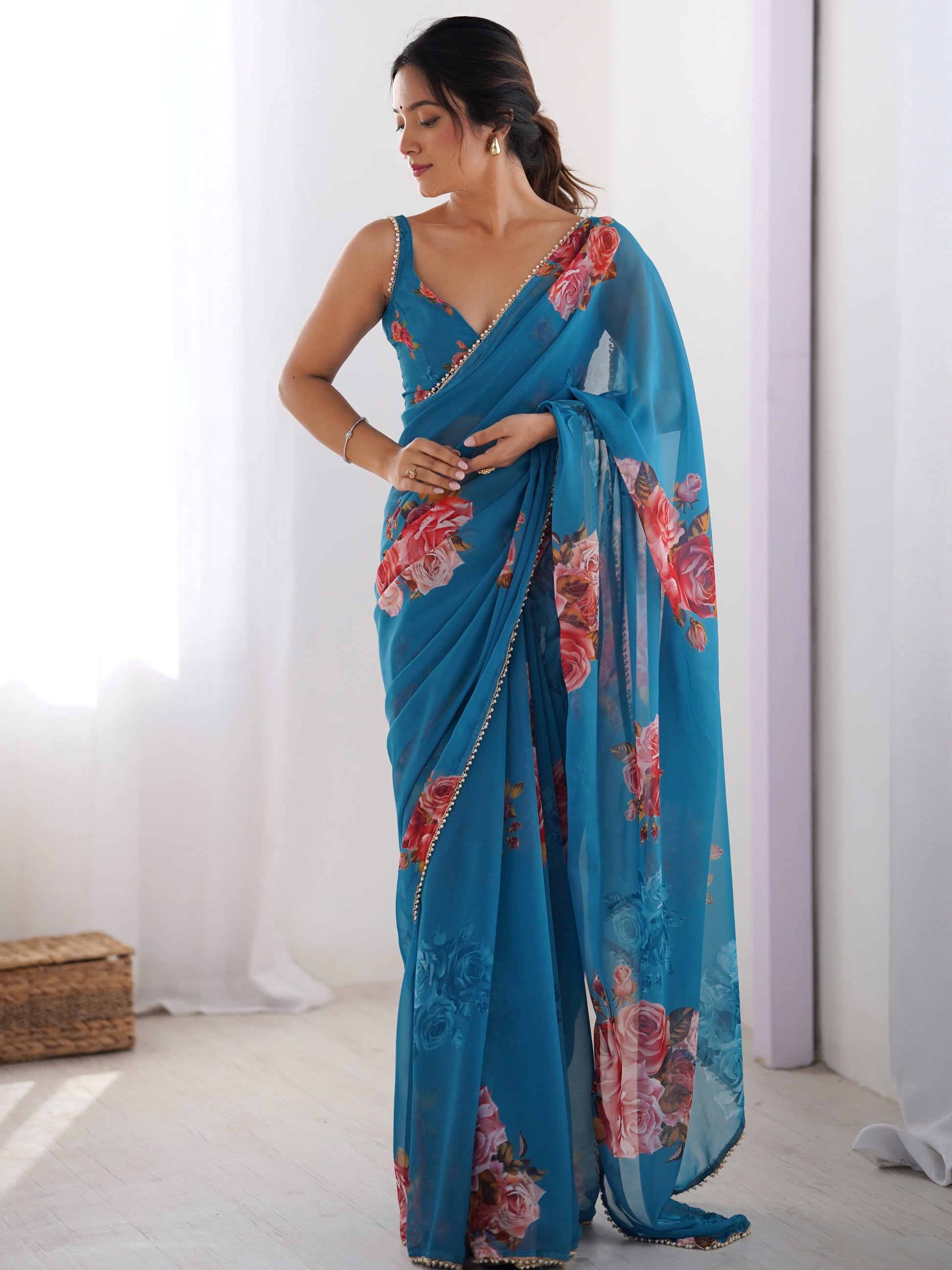 Attractive Teal Blue Floral Printed Georgette Casual Wear Saree