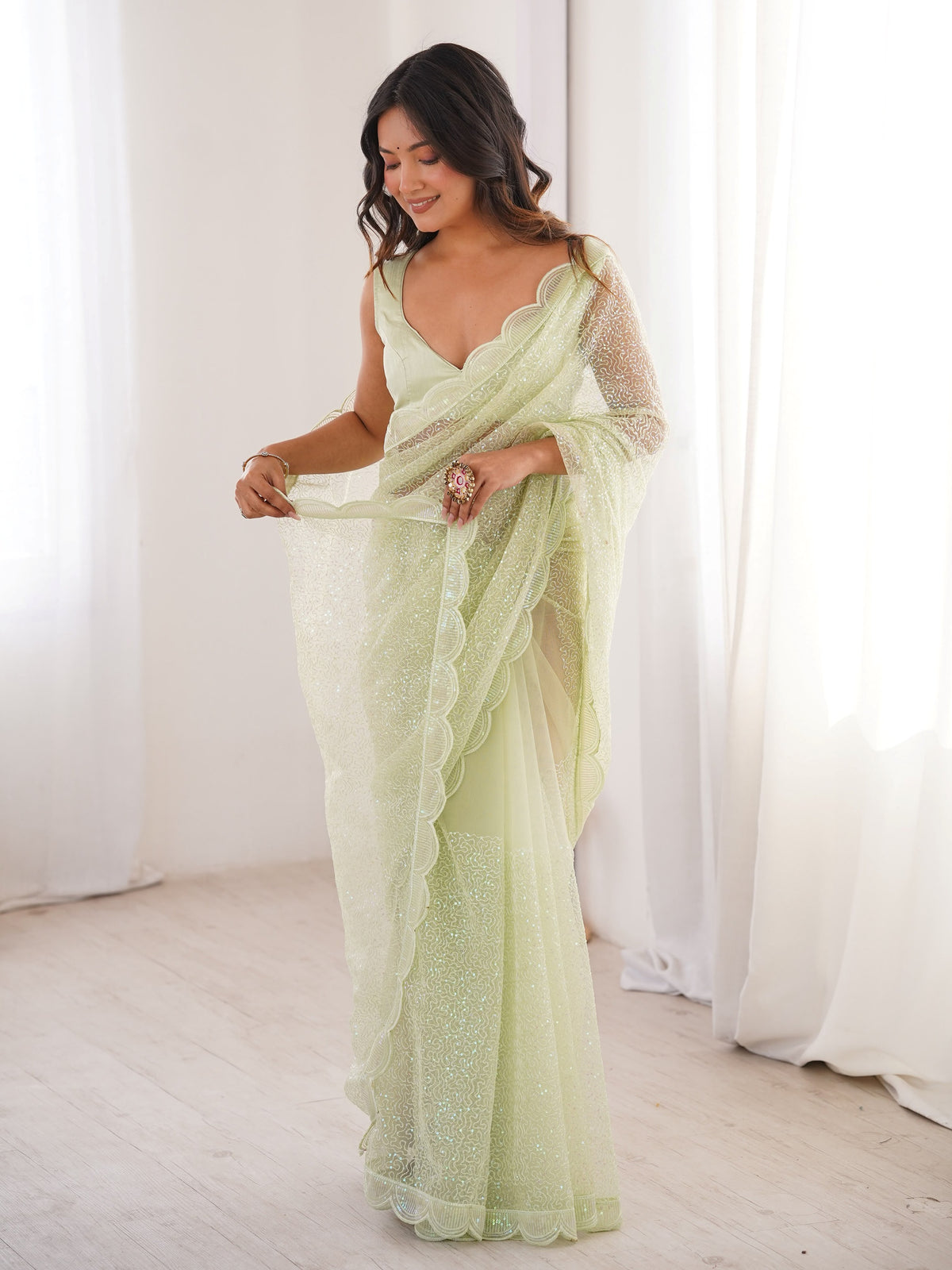Fascinating Pista Green Sequins Work Net Festival Wear Saree