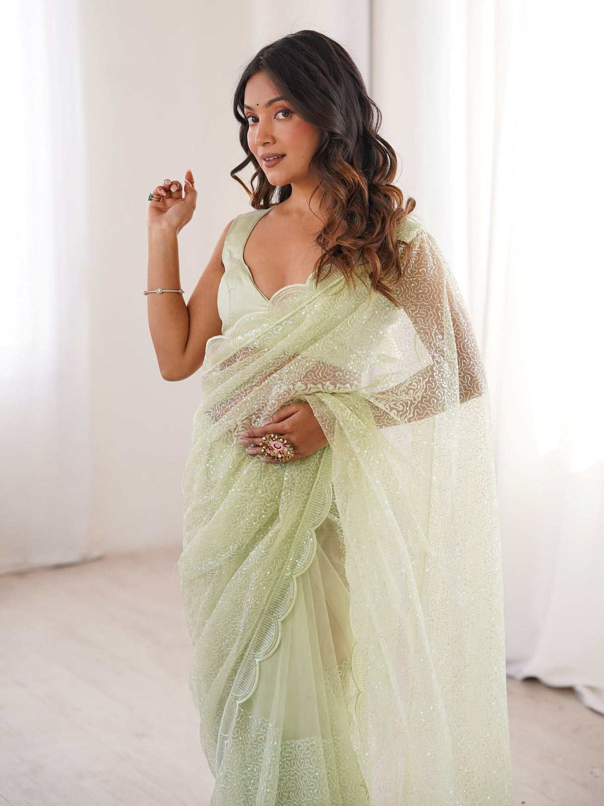 Fascinating Pista Green Sequins Work Net Festival Wear Saree