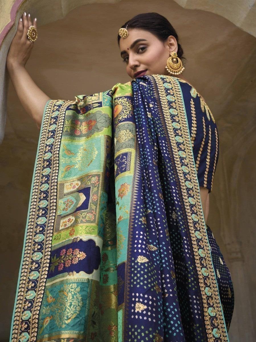 Woman in elegant blue and green printed saree with gold border, traditional Indian fashion