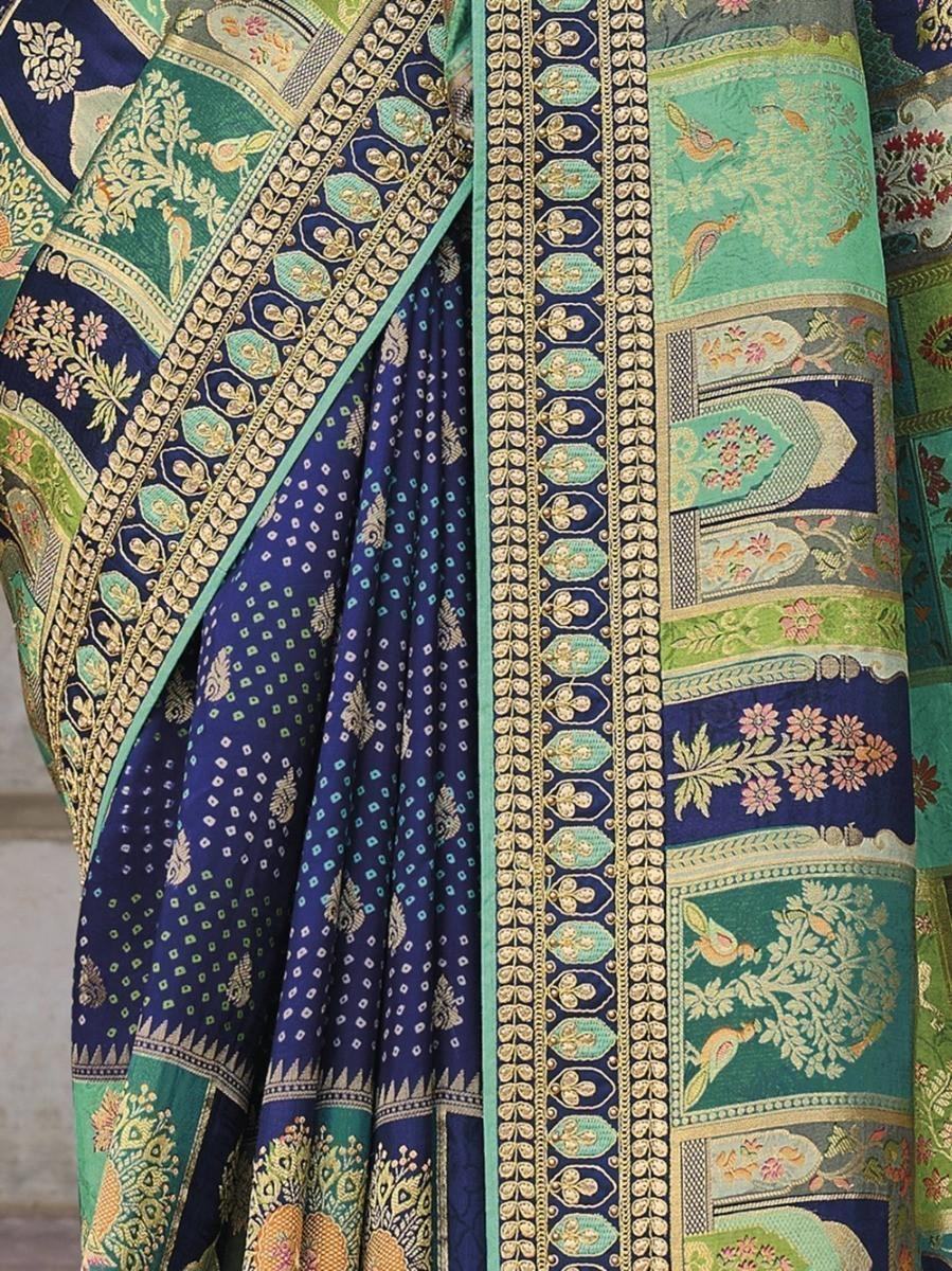 Elegant blue and green printed saree with intricate gold embroidery and floral motifs, perfect for festive occasions.