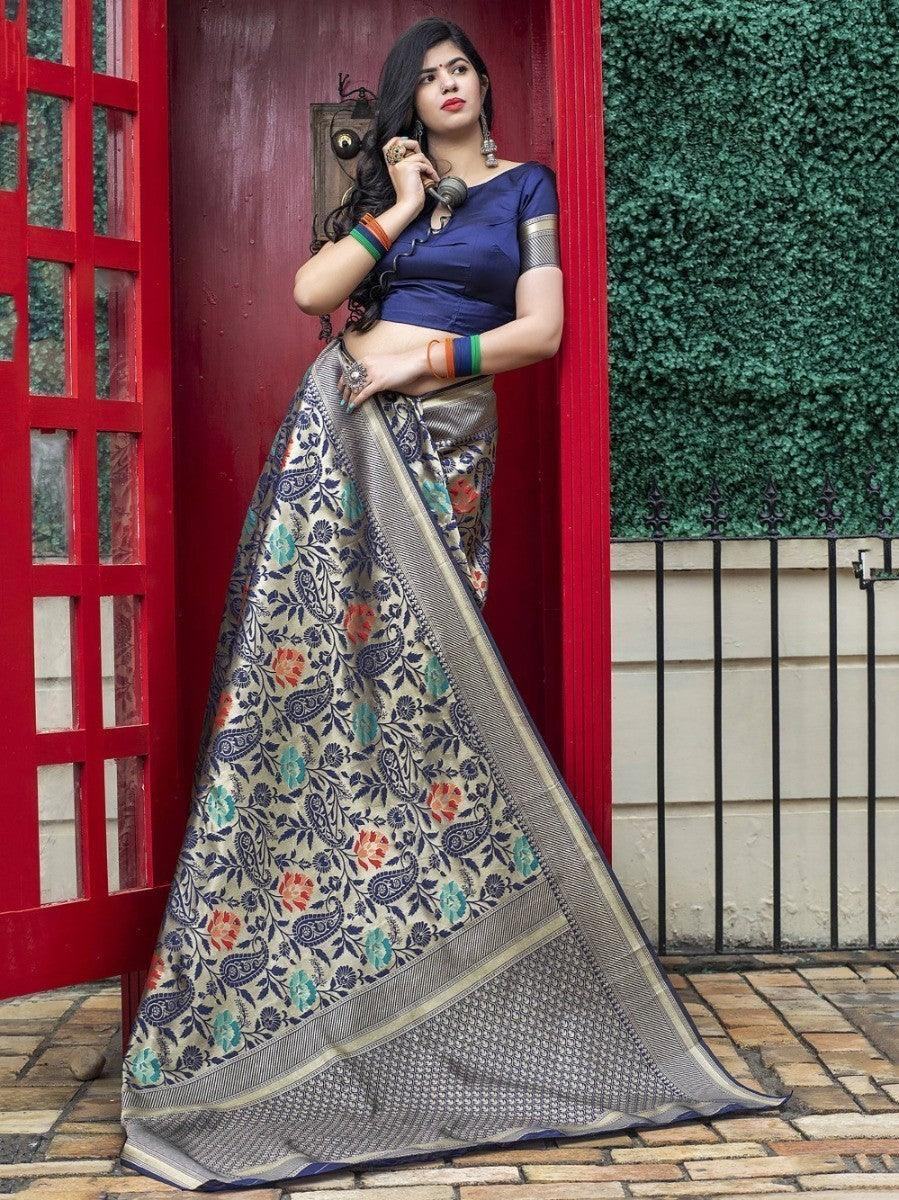Woman in floral paisley saree with blue blouse, standing by red door, fashion outfit