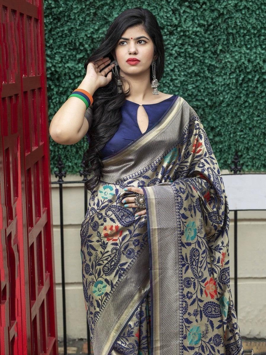 Woman in elegant floral saree with blue blouse, traditional Indian attire for women