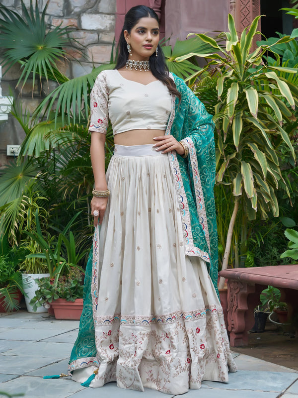 Alluring Off-White Embroidered Silk Lehenga Choli With Teal Dupatta