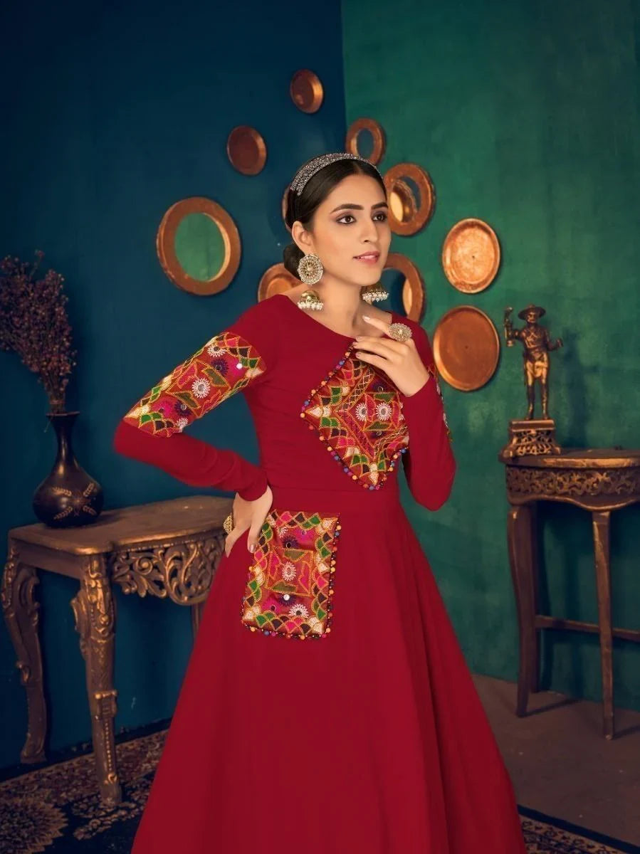 Red embroidered anarkali dress with colorful mirror work, perfect for festive occasions and traditional events