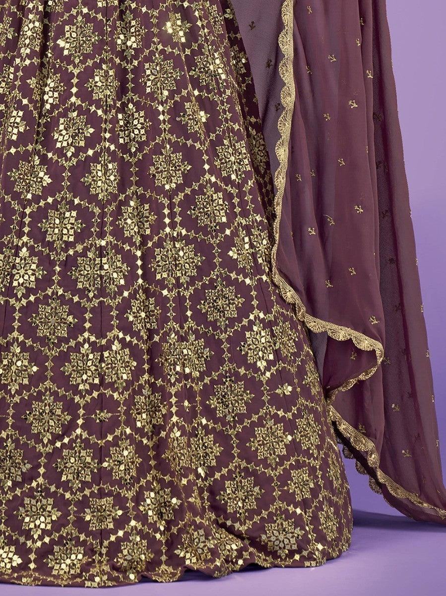 Elegant maroon lehenga with gold embroidery and scalloped dupatta, perfect for festive occasions.