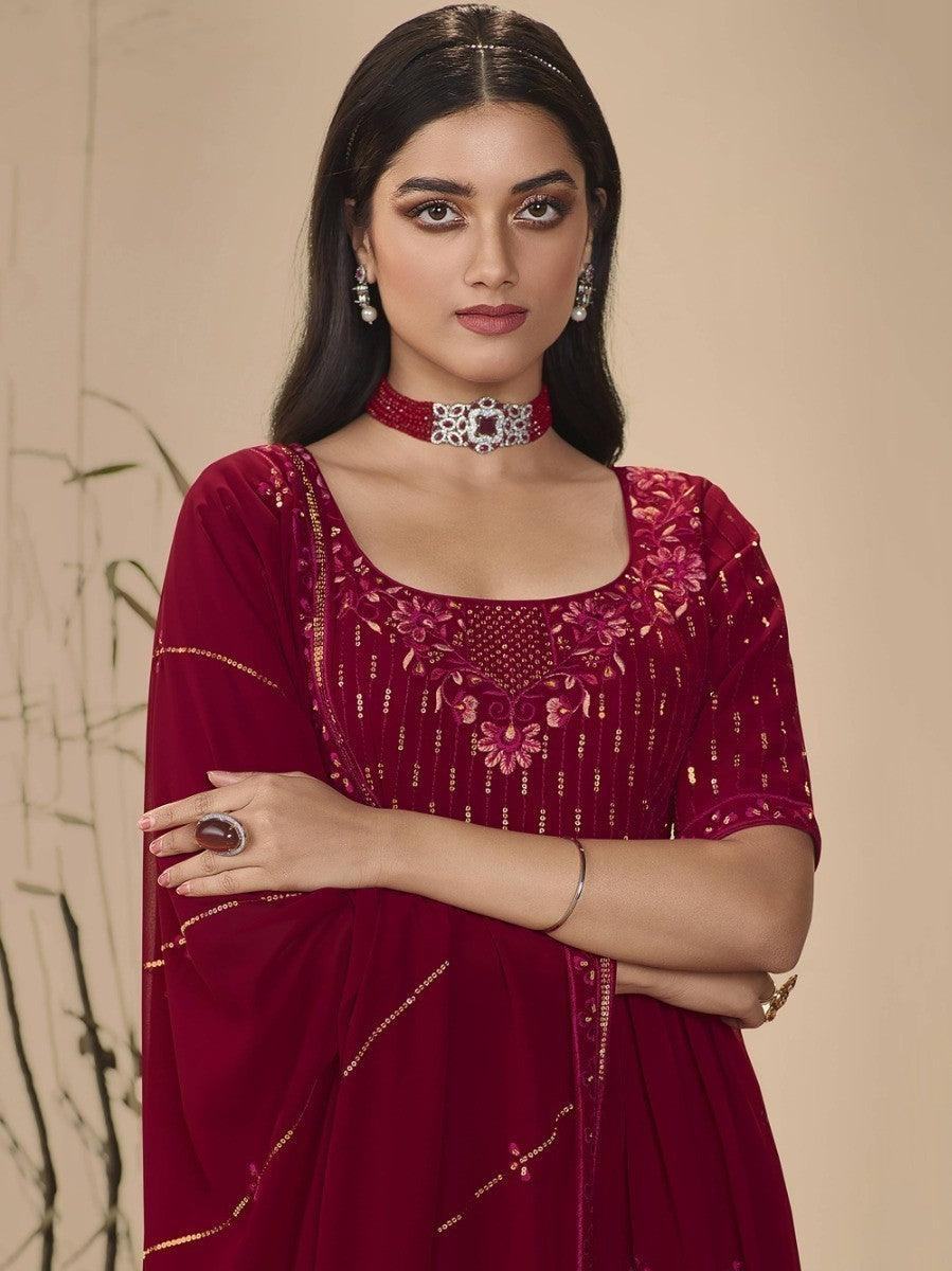Elegant maroon embroidered anarkali gown with gold detailing, perfect for festive occasions