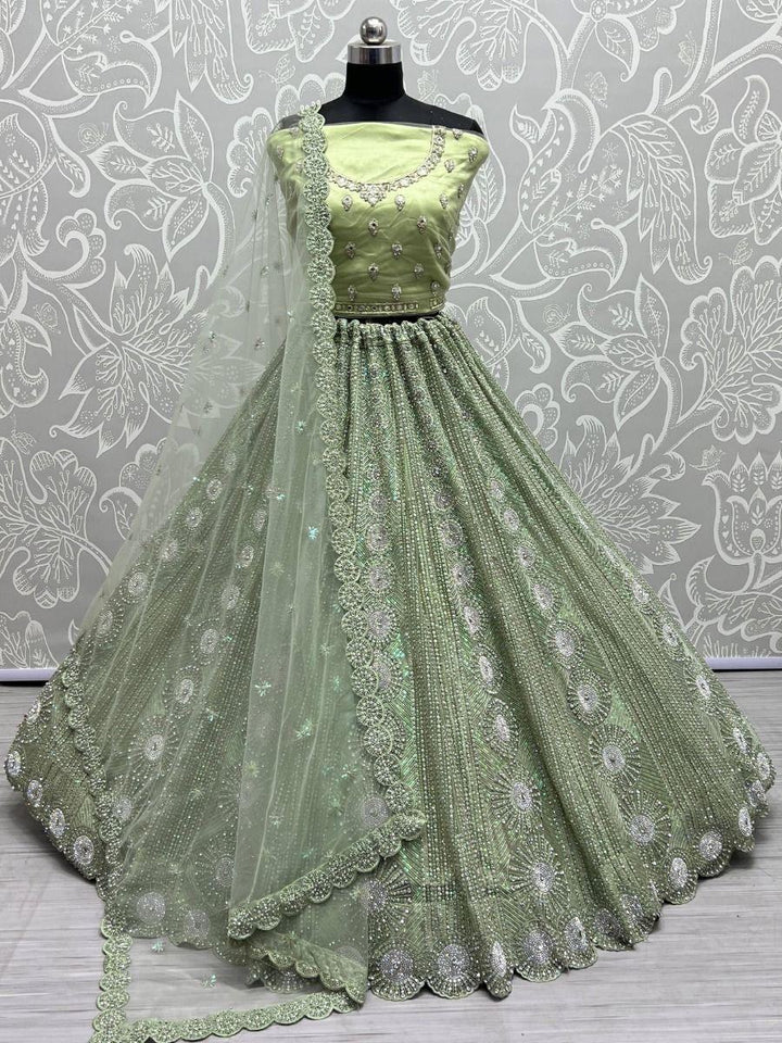 Attractive Pista Green Sequins Net Engagement Wear Lehenga Choli