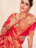 Woman in vibrant red and gold embroidered saree with traditional jewelry, perfect for festive occasions