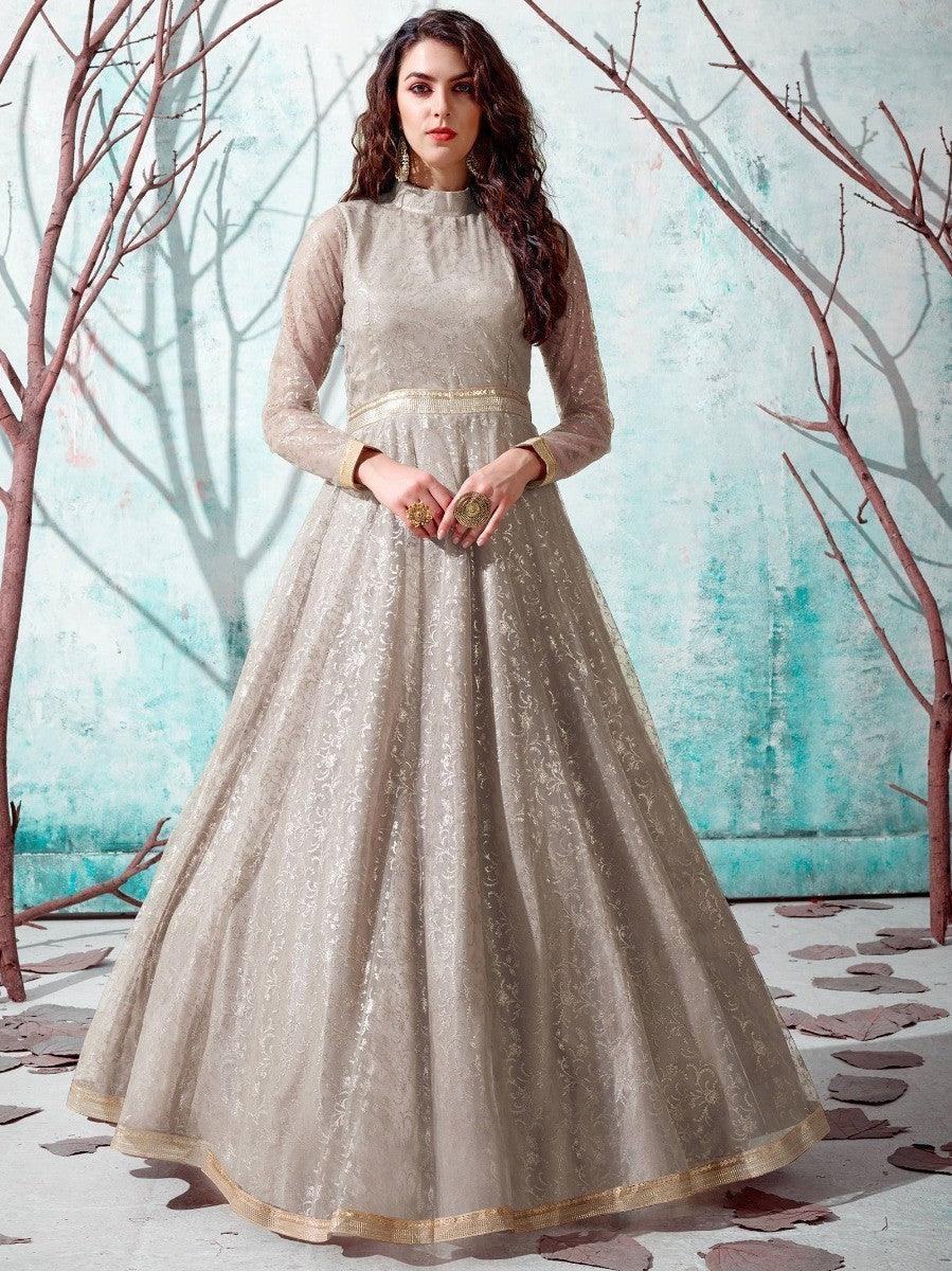 Elegant beige embroidered anarkali gown with gold trim, perfect for festive occasions and women's fashion events.