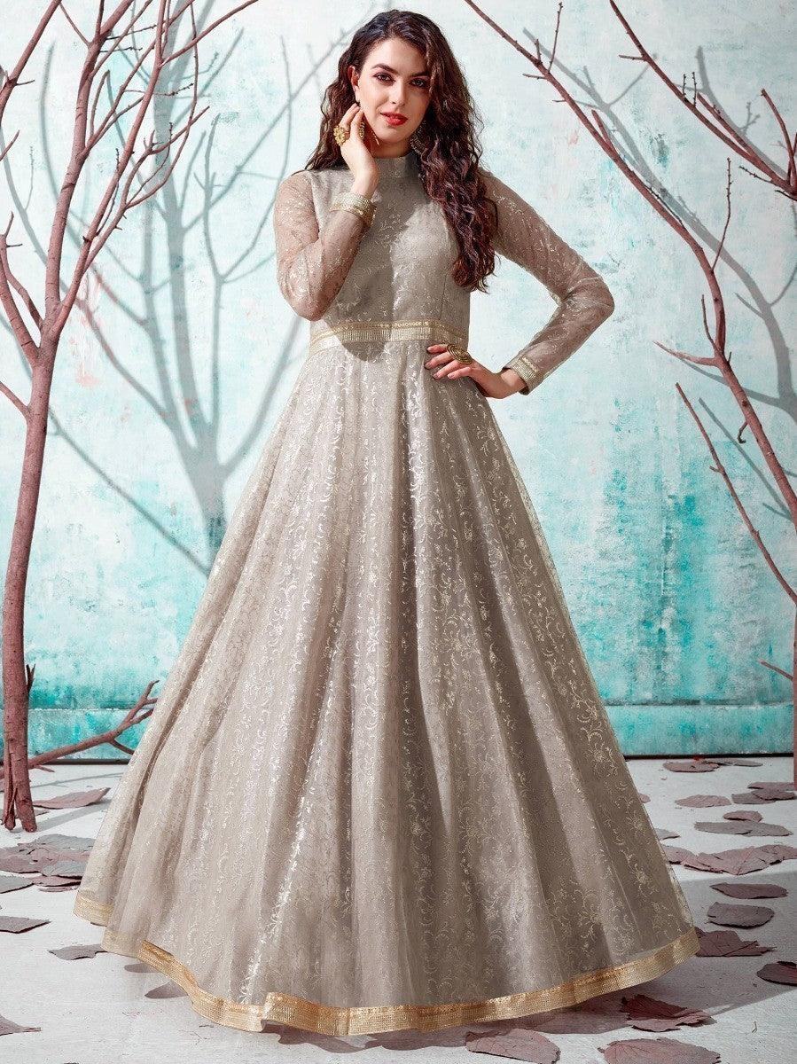 Elegant beige embroidered anarkali gown with gold trim, perfect for festive occasions and women's fashion events.