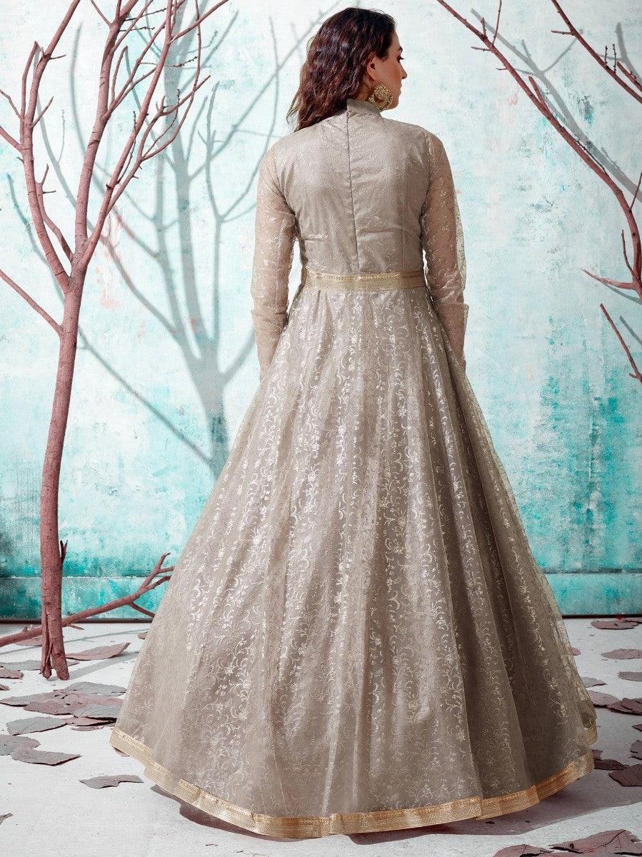 Elegant beige embroidered anarkali gown with gold trim, perfect for festive occasions