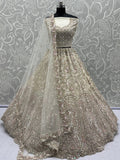 Charming Cream Zircon Work Net Bridesmaid Lehenga Choli With Dupatta - Zeel Clothing