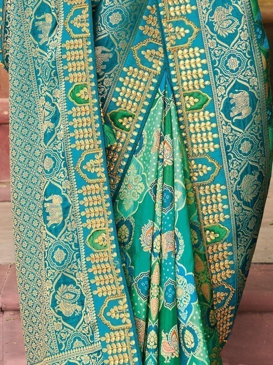 Teal and green embroidered saree with gold floral and elephant motifs, traditional Indian fashion