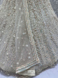 Dazzling Beige Zari Work Net Evening Wear Lehenga Choli With Dupatta