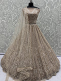 Enchanting Beige Embroidered Net Wedding Wear Lehenga Choli With Dupatta