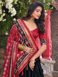 Fascinating Black Patola Printed Tussar Silk Lehenga Choli With Dupatta - Zeel Clothing