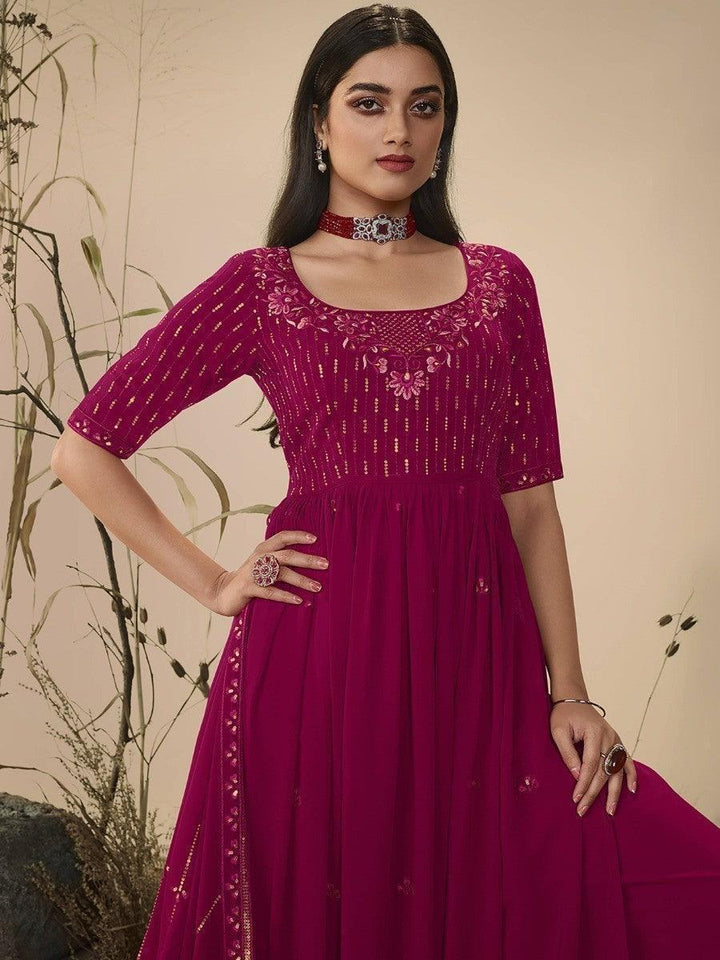 Elegant magenta embroidered anarkali dress with gold detailing, perfect for festive occasions and women's fashion.