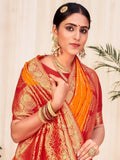 Woman in red and orange traditional saree with gold embroidery and jewelry, elegant ethnic wear