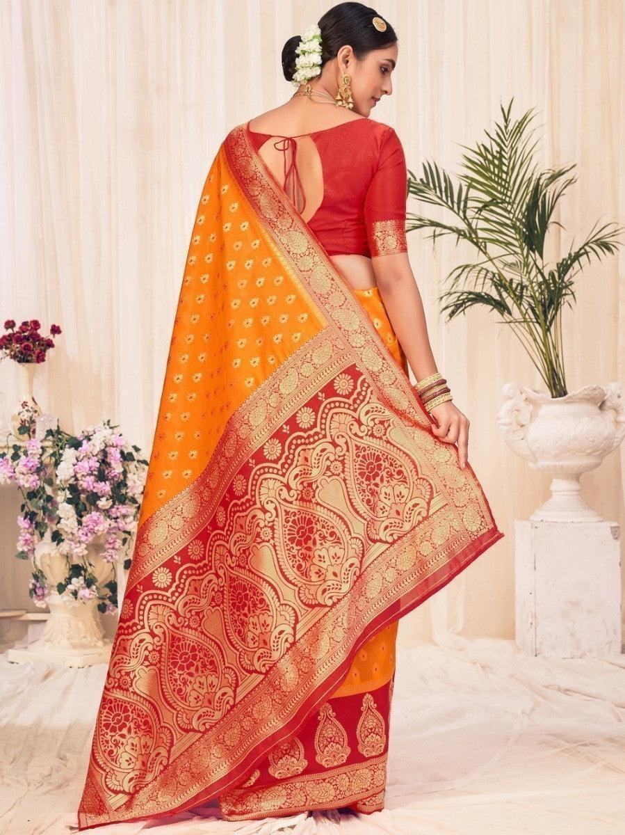 Orange and red embroidered saree with gold paisley border, worn with back-tie blouse for women's ethnic fashion