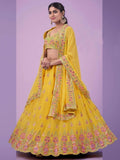 Yellow embroidered lehenga choli with floral mirror work, perfect for festive occasions and weddings