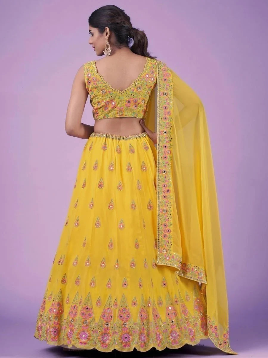 Yellow embroidered lehenga choli with floral motifs and sheer dupatta, back view