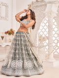 Elegant sage green lehenga choli with white floral embroidery, perfect for festive occasions and weddings.