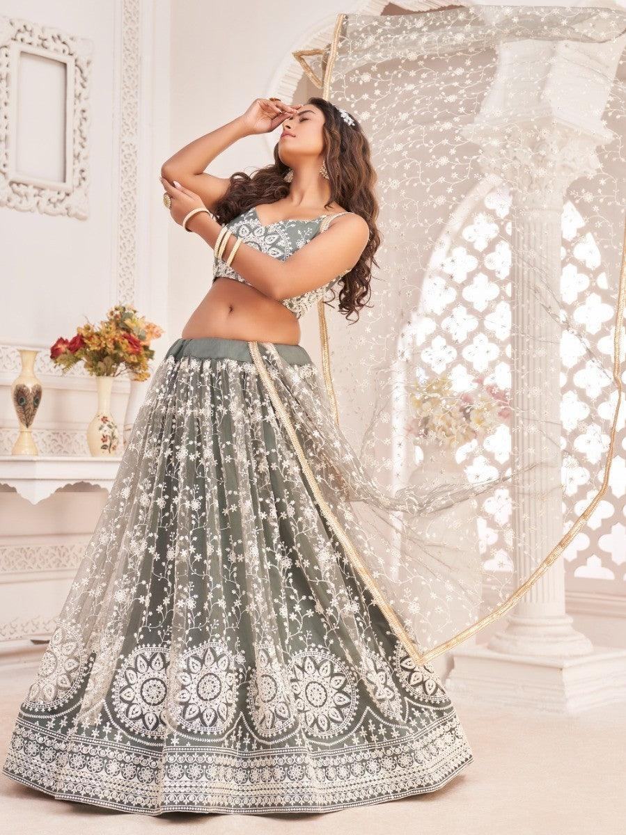 Elegant sage green lehenga choli with white floral embroidery, perfect for festive occasions and weddings.