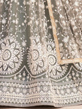 Elegant olive green lehenga with intricate white floral embroidery and gold trim, perfect for festive occasions.