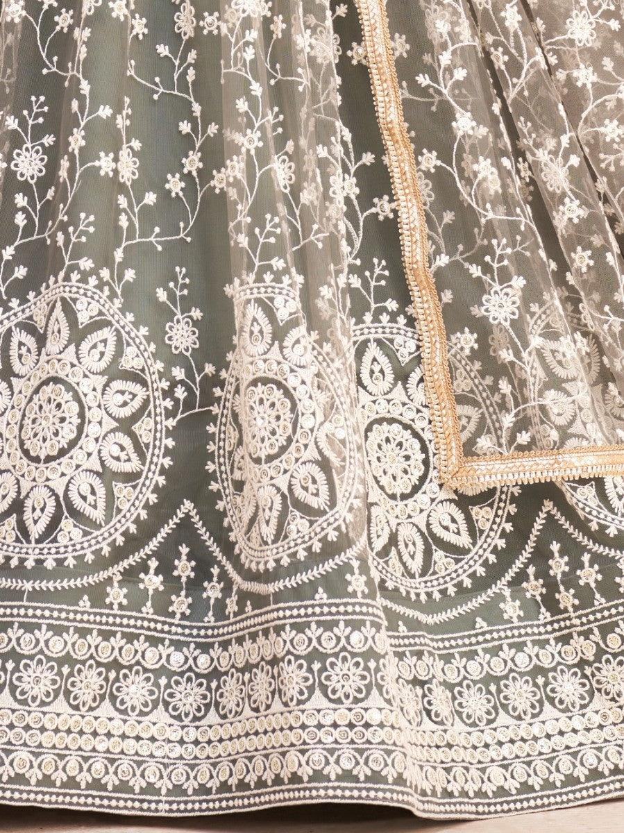 Elegant olive green lehenga with intricate white floral embroidery and gold trim, perfect for festive occasions.