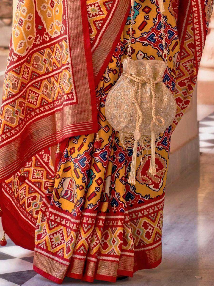 Mesmerizing Mustard Yellow Patola Printed Silk Wedding Saree - Zeel Clothing