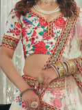 Floral embroidered lehenga with red gold detailing, pearl jewelry, and traditional Indian bridal wear