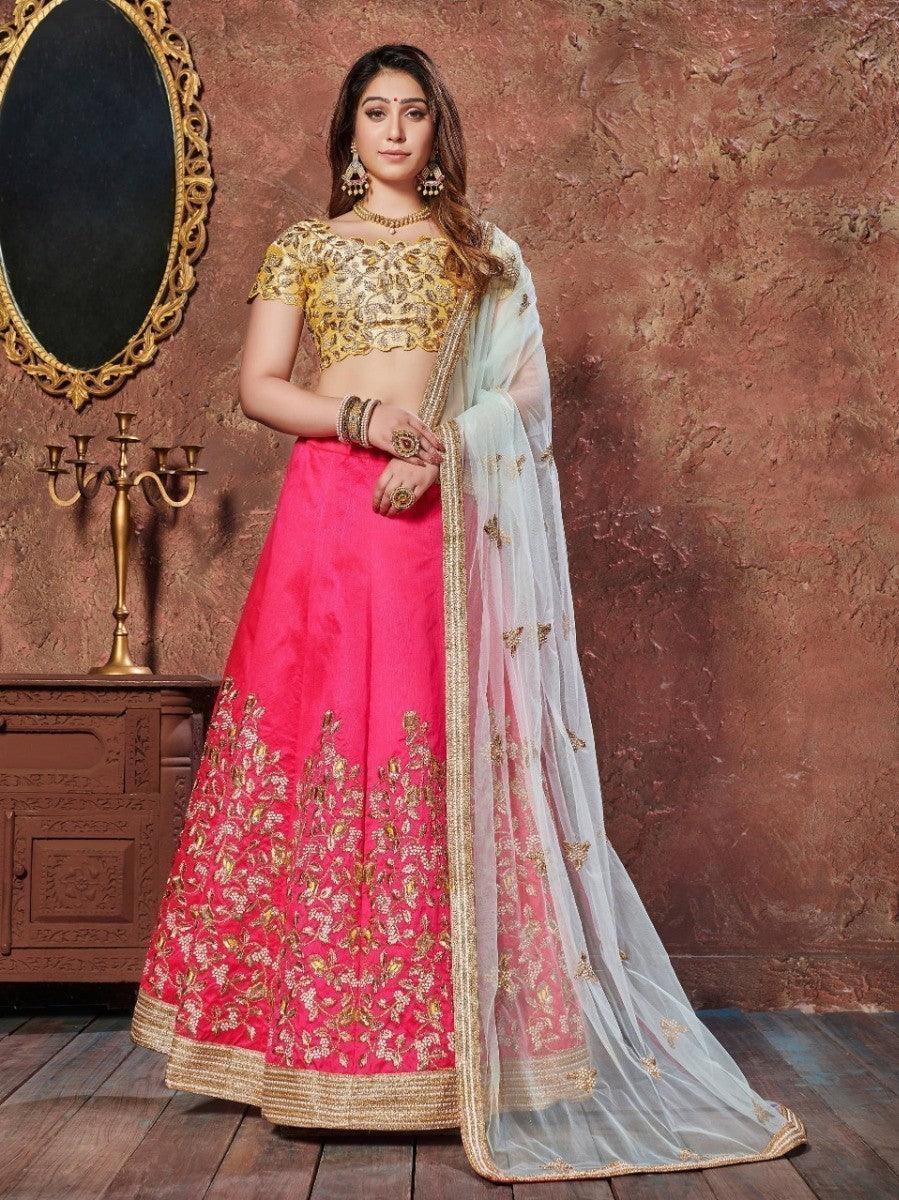 Woman in navy blue floral saree with silver border, traditional jewelry, and red lipstick