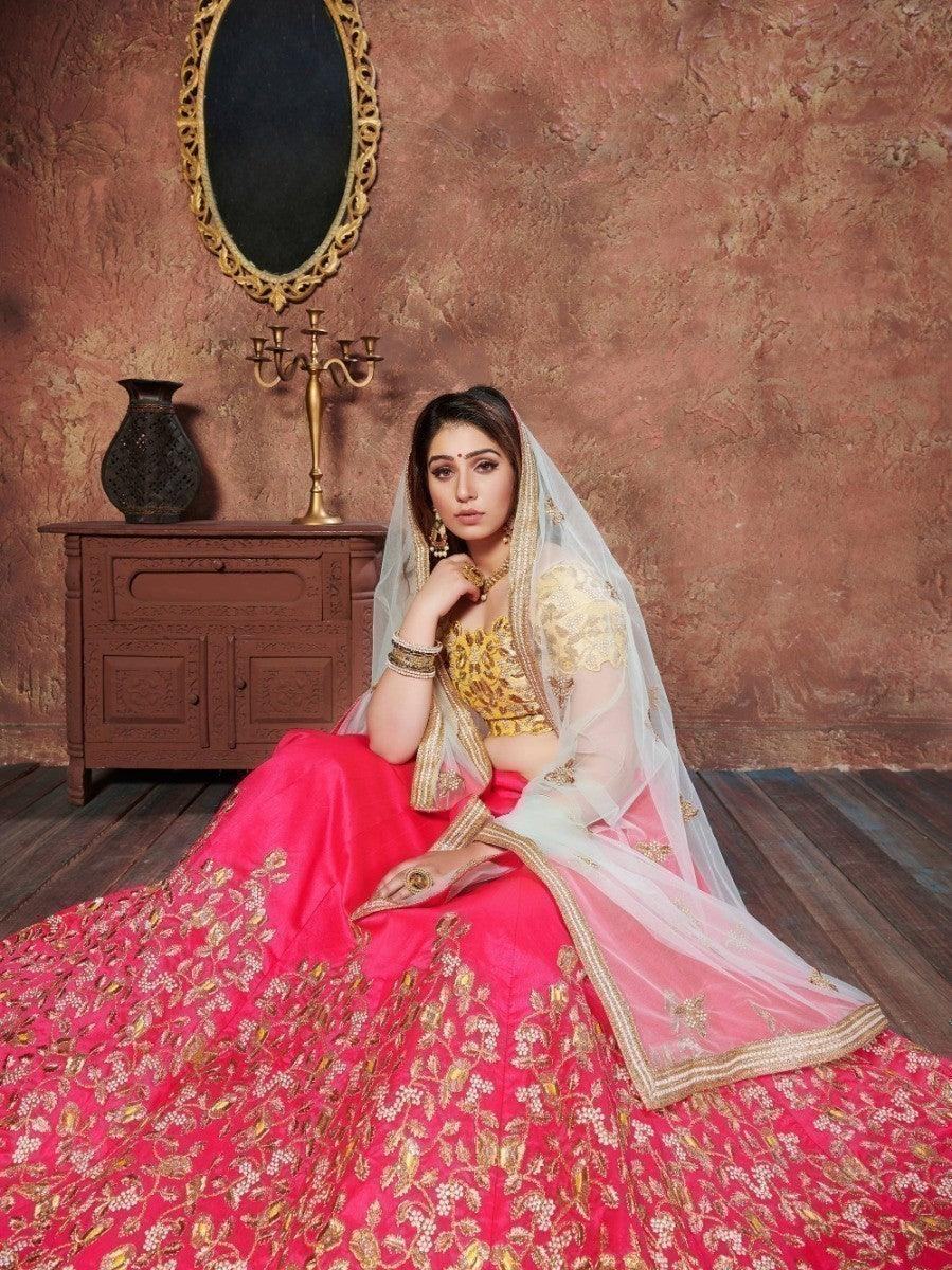 Pink and gold embroidered lehenga with sheer dupatta, perfect for weddings and festive occasions