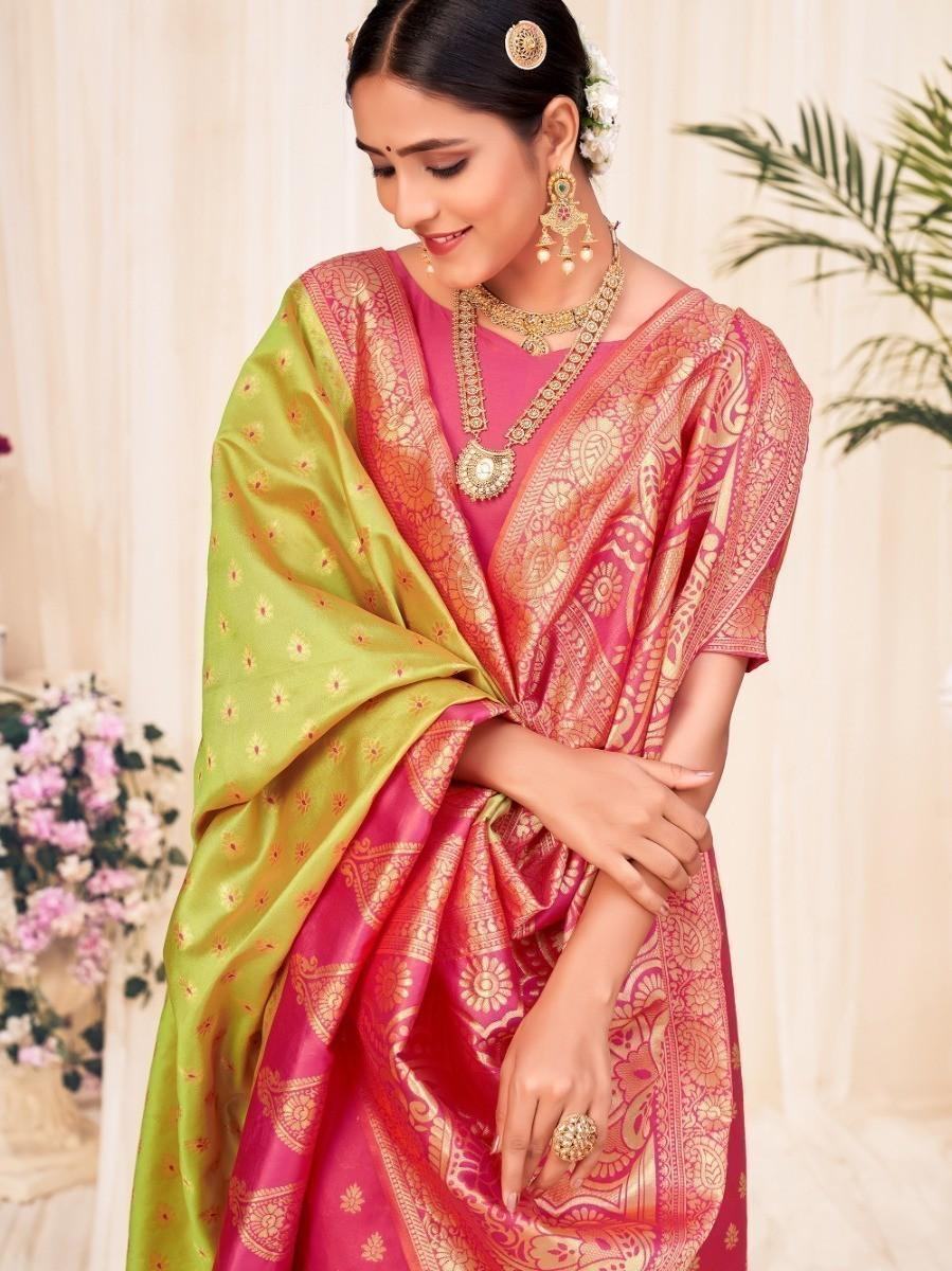 Woman in pink and green traditional saree with gold embroidery, elegant ethnic wear for women
