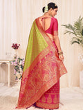 Woman in pink and green designer saree with gold paisley border, back view, traditional Indian fashion