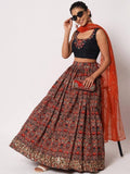 Woman in floral lehenga with black embroidered crop top and orange dupatta, stylish ethnic wear